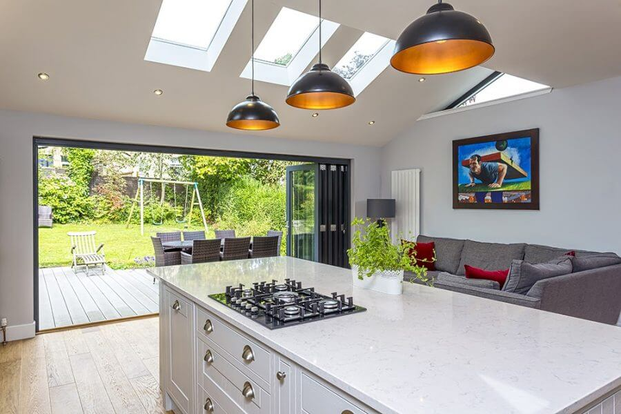 a modern kitchen with garden views